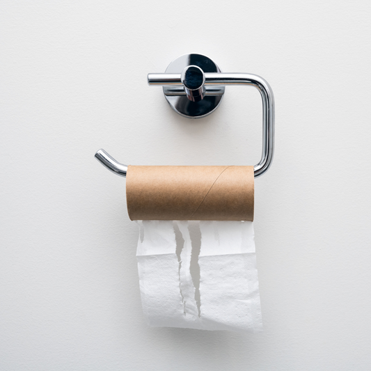 Empty toilet paper roll on a chrome holder against a white bathroom wall Let me know if you'd like a more playful or cheeky version to match your blog tone!